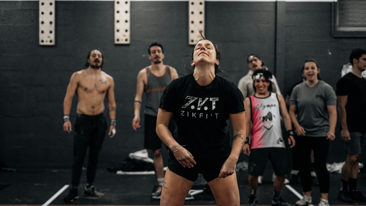 a group of people standing around a gym
